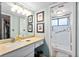 Bathroom with single sink vanity, shower, and grab bars at 1701 Pelican Cove Rd # 359, Sarasota, FL 34231