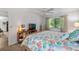 Bedroom with king bed, coastal bedding, and built-in shelving at 1701 Pelican Cove Rd # 359, Sarasota, FL 34231