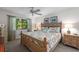 Main bedroom with king-size bed, coastal bedding, and wood dresser at 1701 Pelican Cove Rd # 359, Sarasota, FL 34231