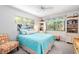Guest bedroom with queen bed, coastal decor, and built-in shelving at 1701 Pelican Cove Rd # 359, Sarasota, FL 34231