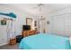 Guest bedroom with queen bed, coastal decor, and dresser at 1701 Pelican Cove Rd # 359, Sarasota, FL 34231