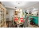 Open dining area with stylish table and view of kitchen at 1701 Pelican Cove Rd # 359, Sarasota, FL 34231