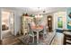 Bright dining room with table, chairs, and hutch at 1701 Pelican Cove Rd # 359, Sarasota, FL 34231
