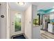 Bright entryway with glass door and view of kitchen at 1701 Pelican Cove Rd # 359, Sarasota, FL 34231