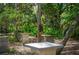Landscaped garden area with stone seating and wind chimes at 1701 Pelican Cove Rd # 359, Sarasota, FL 34231