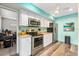 Modern kitchen with stainless steel appliances and light wood flooring at 1701 Pelican Cove Rd # 359, Sarasota, FL 34231