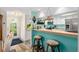 Charming kitchen with light teal walls and stainless steel appliances at 1701 Pelican Cove Rd # 359, Sarasota, FL 34231