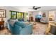 Relaxing living room featuring sectional sofa and wood floors at 1701 Pelican Cove Rd # 359, Sarasota, FL 34231