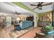 Bright sunroom addition with tile floors and seating at 1701 Pelican Cove Rd # 359, Sarasota, FL 34231