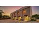 Four modern townhomes at dusk with a brick driveway at 1762 10Th St, Sarasota, FL 34236