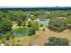 Aerial view of neighborhood featuring park, pond, and tennis court at 1778 10Th St, Sarasota, FL 34236