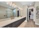 Bathroom with double vanity, large mirror, and walk-in shower at 18096 Home Run Dr, Venice, FL 34293