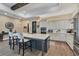 Modern kitchen with island, white cabinets, and stainless steel appliances at 18096 Home Run Dr, Venice, FL 34293
