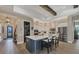 Modern kitchen with an island, white cabinets, and stainless steel appliances at 18096 Home Run Dr, Venice, FL 34293