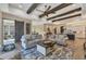 Spacious living room with hardwood floors, exposed beams, and comfortable seating at 18096 Home Run Dr, Venice, FL 34293