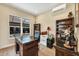 Home office featuring built-in shelving and hardwood floors at 18096 Home Run Dr, Venice, FL 34293