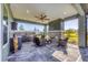 Covered patio with outdoor kitchen, fireplace, and seating at 18096 Home Run Dr, Venice, FL 34293