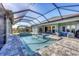 Luxury screened pool and spa with patio furniture at 18096 Home Run Dr, Venice, FL 34293