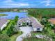 Luxury home on waterfront lot with expansive landscaping and large driveway at 19458 Beacon Park Pl, Lakewood Ranch, FL 34202