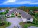 Luxury home with lake views, spacious driveway, and lush landscaping at 19458 Beacon Park Pl, Lakewood Ranch, FL 34202