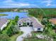 Luxury home with lake views, spacious driveway, and lush landscaping at 19458 Beacon Park Pl, Lakewood Ranch, FL 34202