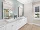 Elegant bathroom with double sinks and a large vanity at 19458 Beacon Park Pl, Lakewood Ranch, FL 34202