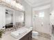 Bathroom with a walk-in shower and floating sink at 19458 Beacon Park Pl, Lakewood Ranch, FL 34202