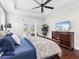 Main bedroom with a dresser and access to the balcony at 19458 Beacon Park Pl, Lakewood Ranch, FL 34202