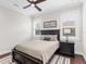 Guest bedroom with a comfortable bed and nightstand at 19458 Beacon Park Pl, Lakewood Ranch, FL 34202