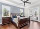 Spacious bedroom with a ceiling fan and private access to patio at 19458 Beacon Park Pl, Lakewood Ranch, FL 34202