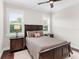 Bedroom with a double bed, nightstand and window shutters at 19458 Beacon Park Pl, Lakewood Ranch, FL 34202