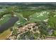 Aerial view of the Concession Golf Clubhouse, surrounded by lush landscaping and parking at 19458 Beacon Park Pl, Lakewood Ranch, FL 34202