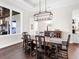 Formal dining room with hardwood floors, chandelier, and wood table at 19458 Beacon Park Pl, Lakewood Ranch, FL 34202