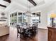 Bright dining room with hardwood floors, large windows, and a view of the pool at 19458 Beacon Park Pl, Lakewood Ranch, FL 34202