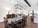 Elegant dining room features dark wood table and chandelier at 19458 Beacon Park Pl, Lakewood Ranch, FL 34202