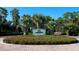 Golf clubhouse entrance with lush landscaping at 19458 Beacon Park Pl, Lakewood Ranch, FL 34202