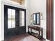 Bright and spacious entryway with double doors and a console table at 19458 Beacon Park Pl, Lakewood Ranch, FL 34202