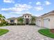 Elegant home with a three-car garage and stone driveway at 19458 Beacon Park Pl, Lakewood Ranch, FL 34202