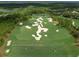 Aerial view of the Concession Golf Course showing a hole with sand traps and lush greens at 19458 Beacon Park Pl, Lakewood Ranch, FL 34202