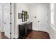 Hallway with dark wood floors and a console table at 19458 Beacon Park Pl, Lakewood Ranch, FL 34202