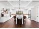 Bright kitchen with white cabinets, large island, and hardwood floors at 19458 Beacon Park Pl, Lakewood Ranch, FL 34202