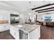 Modern kitchen with large island, white cabinets and farm sink at 19458 Beacon Park Pl, Lakewood Ranch, FL 34202