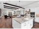 Open concept kitchen with island, white cabinets and hardwood floors at 19458 Beacon Park Pl, Lakewood Ranch, FL 34202