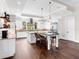 Open kitchen boasts white cabinets, stainless steel appliances, and hardwood floors at 19458 Beacon Park Pl, Lakewood Ranch, FL 34202