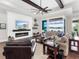 Spacious living room with hardwood floors, a fireplace, and access to a backyard patio at 19458 Beacon Park Pl, Lakewood Ranch, FL 34202