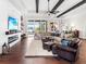 Bright and airy living room with hardwood floors, large windows, and a comfortable seating arrangement at 19458 Beacon Park Pl, Lakewood Ranch, FL 34202