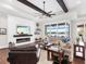 Spacious living area with hardwood floors, fireplace and access to a backyard patio at 19458 Beacon Park Pl, Lakewood Ranch, FL 34202