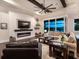 Living room with hardwood floors, fireplace, and views to a lake at dusk at 19458 Beacon Park Pl, Lakewood Ranch, FL 34202