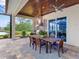 Outdoor kitchen and dining area with a lake view at 19458 Beacon Park Pl, Lakewood Ranch, FL 34202