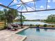 Relaxing pool area with lounge chairs and lake view at 19458 Beacon Park Pl, Lakewood Ranch, FL 34202